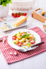 delicious gnocchi with gorgonzola cream sauce and cherry tomatoes