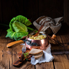 young and fresh cabbage cooked with bacon cubes