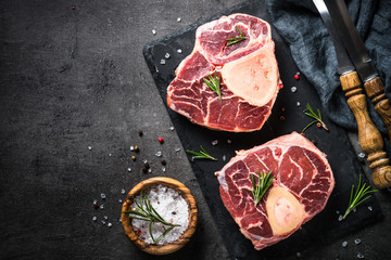 Raw beef steak osso bucco on black. Marble meat.