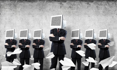 Businessmen with monitors instead of head.