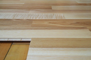 An image of an old parquet and a new parquet board.