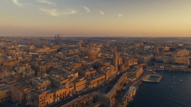 Aerial shot flying backwards at Sunset in Malta