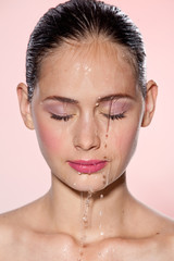 Beautiful Model Girl with splashes of water on her face. Beautiful Woman under splash of water with...