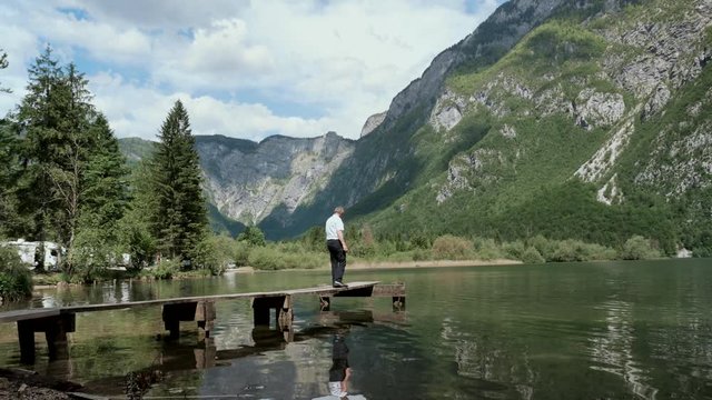 Man walking on platform bridge on Lake