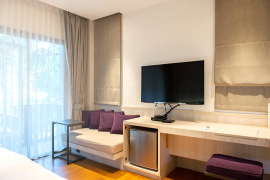 Interior hotel room with LED television and  window blinds