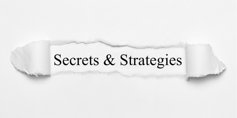 Secrets & Strategies on white torn paper