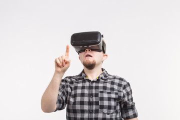 Man wearing virtual reality glasses raising his hand