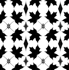 Seamless pattern with maple leaf silhouettes in a black and white colors 