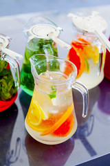 Fototapeta na wymiar fruit drinks in decanters and glasses