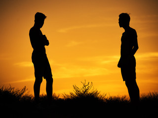silhouettes of two young friends of the guys