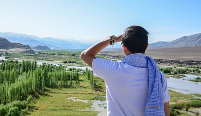 A young traveler looking at mountains