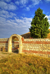 Entrance and stone wall of ancient sanctuary