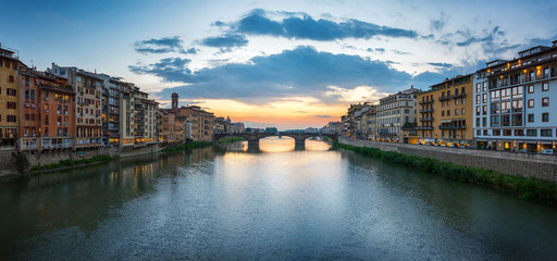 Fototapeta na wymiar View of the Arno river, evening Florence and the St Trinity Bridge. Florence, Italy.