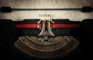 History typed on an old vintage typewriter with paper sheet. Retro style.