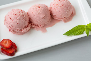 Tasty creamy strawberry ice cream with fresh ripe red succulent fruit 