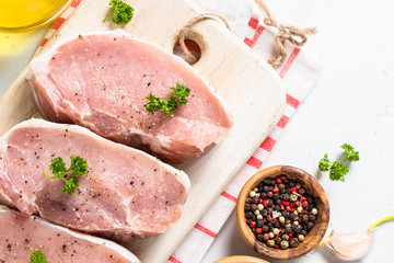 Pork meat steak on white top view. 