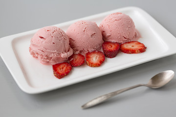 Tasty creamy strawberry ice cream with fresh ripe red succulent fruit 