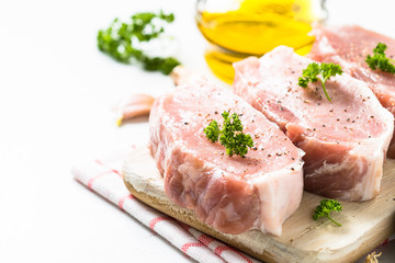 Pork meat steak on white top view. 