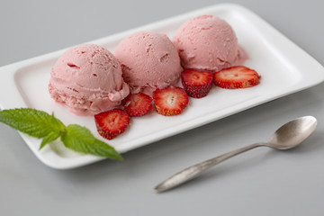 Tasty creamy strawberry ice cream with fresh ripe red succulent fruit 