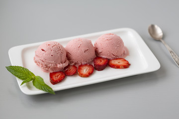 Tasty creamy strawberry ice cream with fresh ripe red succulent fruit 