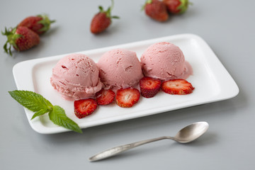 Tasty creamy strawberry ice cream with fresh ripe red succulent fruit 