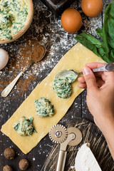 The process of making ravioli with ricotta, spinach and nutmeg