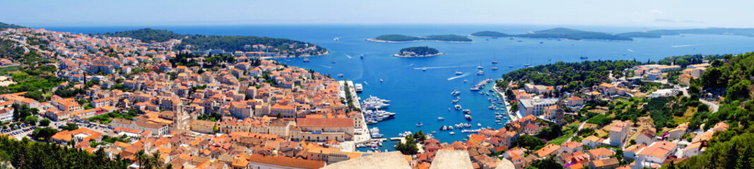 Beautiful wide panorama of Hvar town with the harbor in Croatia - obrazy, fototapety, plakaty