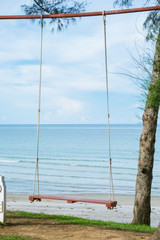 Wooden swing at seaside.relax vacation concept.