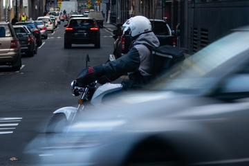 A motorcycle courier riding in the city