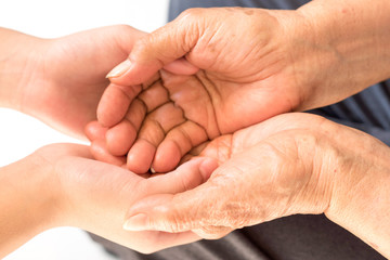 Caregiver, carer hand holding elder hand woman in hospice care. Philanthropy kindness to disabled concept.Public Service Recognition Week