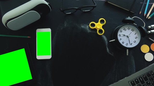 Virtual school mock up background with green screen electronics on other educational accessories on table, top view flat lay with copy space