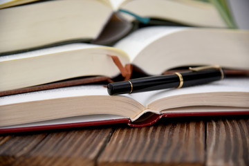 open piled books and feather style