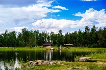 Summer cottage or log cabin by the blue lake in rural Finland.