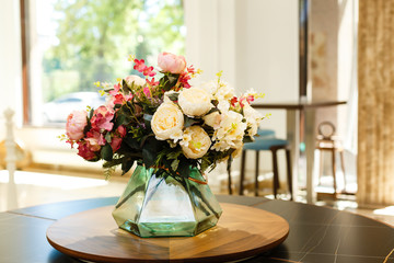 Beautiful flowers in vases on table close up