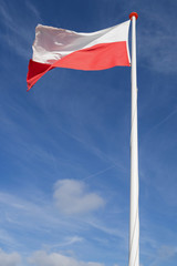 Fototapeta na wymiar Polish flag flying in the wind