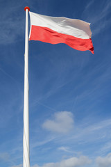 Fototapeta na wymiar Polish flag flying in the wind