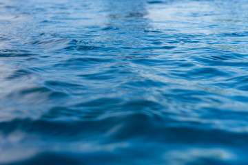 Reflection of blue water surface with small waves