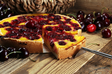 cherry cake and a bunch of cherries on table