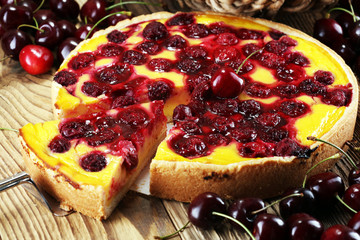 cherry cake and a bunch of cherries on table