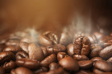 Close up pile of Coffee beans roasting with smoke
