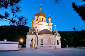 majestically beautiful church at dusk against a clear blue sky