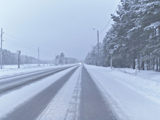 Winter driving on a frozen and slippery highway in Finland.