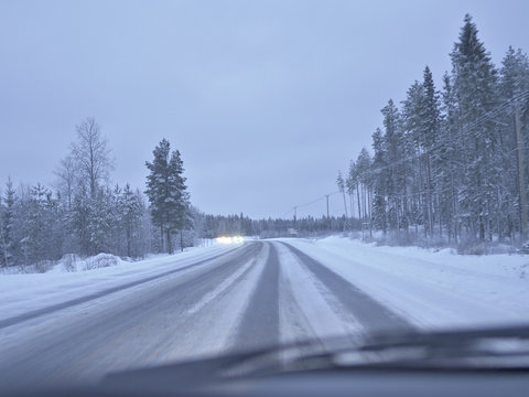 Winter driving on a frozen and slippery highway in Finland.