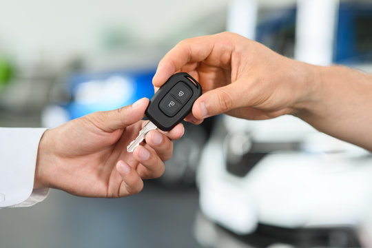 Salesman gives new keys to client
