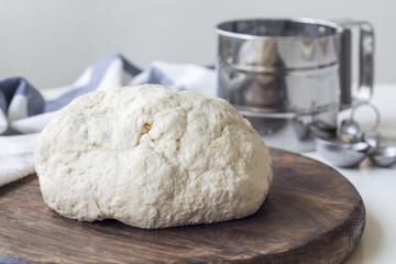 Raw cottage cheese dough on wooden board, horizontal. Making savoury cottage cheese pies with minced meat