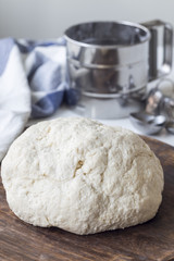 Raw cottage cheese dough on wooden board, vertical. Making savoury cottage cheese pies with minced meat