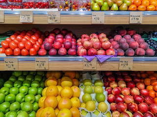 Fresh colorful fruits lined up on a market
