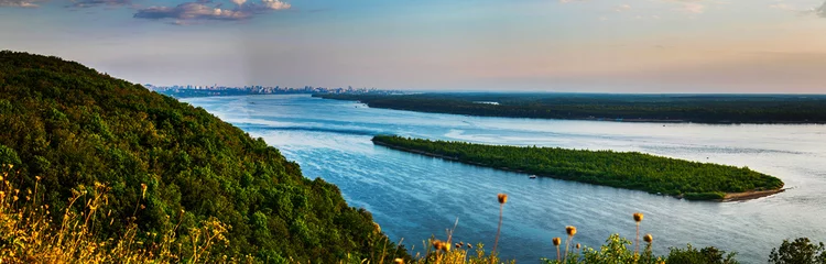 Deurstickers Panoramic view on Volga river and island with green forest during summer sunset from hill near Samara city © VarnakovR