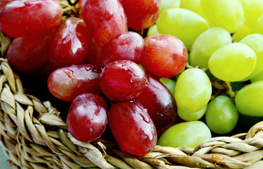 Benefits of  Difference color between Green and Purple grapes.
Green and Purple grapes in basket.