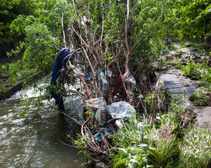 Water pollution. Garbage near the urban stream